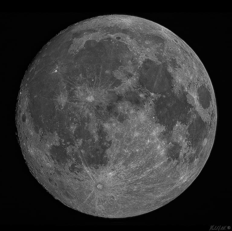 The near-full moon, deep orange during a lunar eclipse